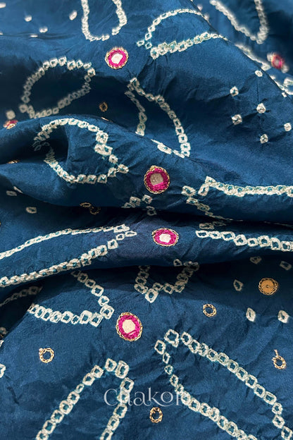 Close-up of Indigo Blue mulberry silk Bandhani (Rai Bandhej) fabric with white tie-dye motifs, zari embroidered pink mirror work and sequin detailing – CHAKOR.
