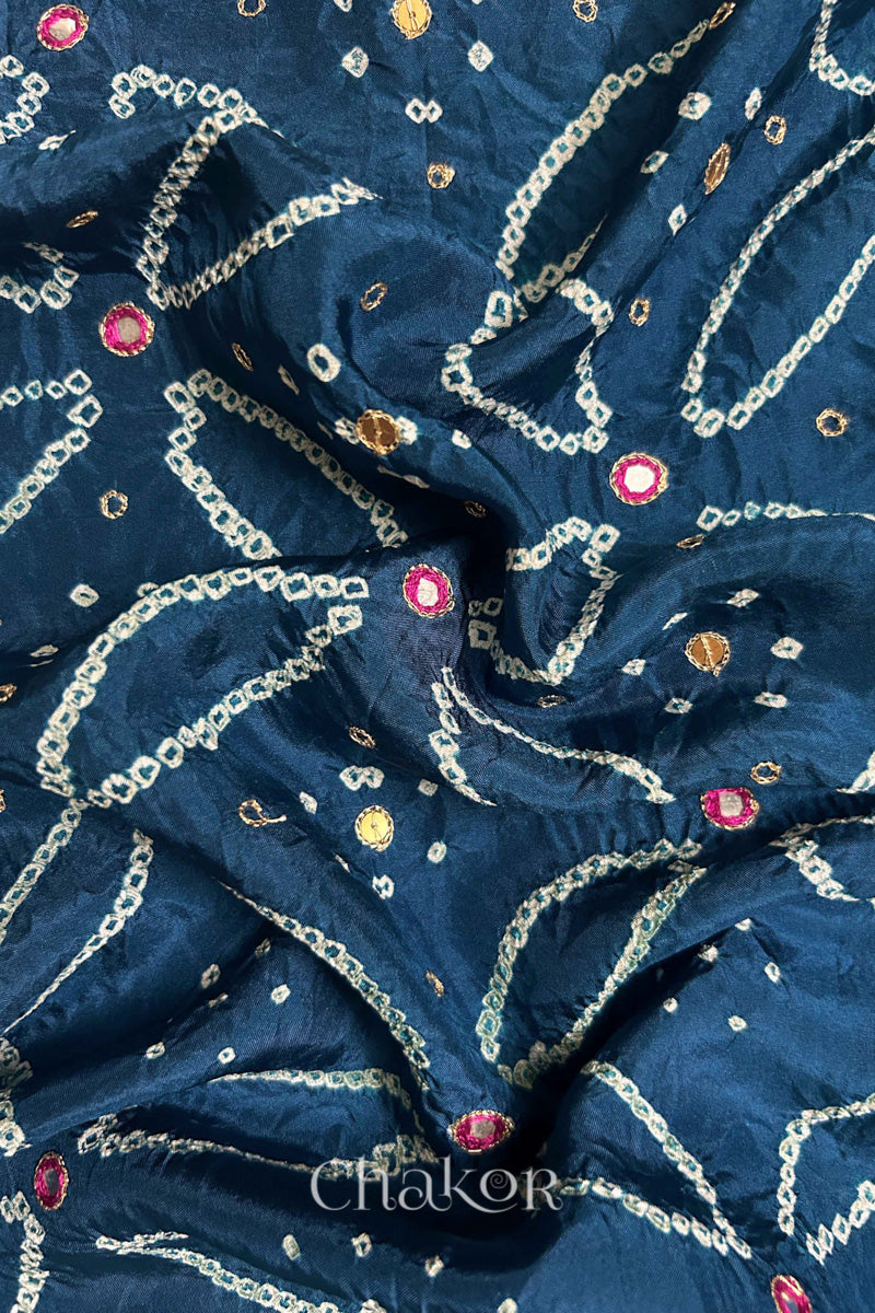 Close-up of Indigo Blue mulberry silk Bandhani (Rai Bandhej) fabric with white tie-dye motifs, zari embroidered pink mirror work and sequin detailing – CHAKOR.
