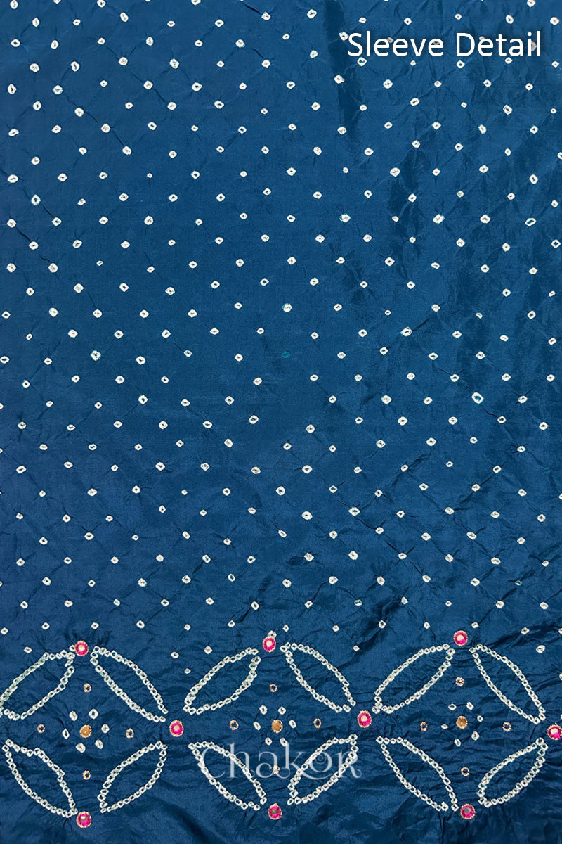 Sleeve detail of Indigo Blue mulberry silk Bandhani (Rai Bandhej) fabric with white dots, floral bandhej borders and pink with zari mirror embroidery – CHAKOR.
