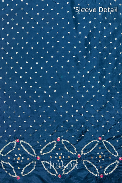 Sleeve detail of Indigo Blue mulberry silk Bandhani (Rai Bandhej) fabric with white dots, floral bandhej borders and pink with zari mirror embroidery – CHAKOR.

