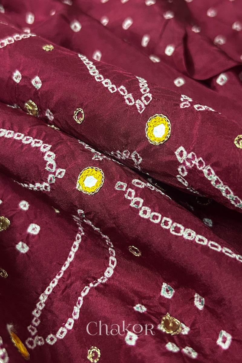Close-up of Dusty Red mulberry silk Bandhani (Rai Bandhej) fabric with white tie-dye motifs, zari embroidered yellow mirror work and sequin detailing – CHAKOR.