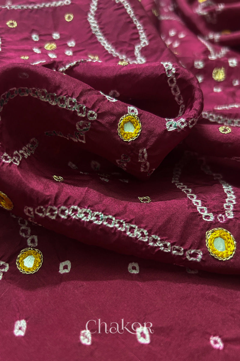 Close-up of Dusty Red mulberry silk Bandhani (Rai Bandhej) fabric with white tie-dye motifs, zari embroidered yellow mirror work and sequin detailing – CHAKOR.