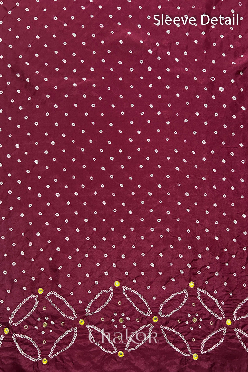 Sleeve detail of Dusty Red mulberry silk Bandhani (Rai Bandhej) fabric with white dots, floral bandhej borders and yellow with zari mirror embroidery – CHAKOR.
