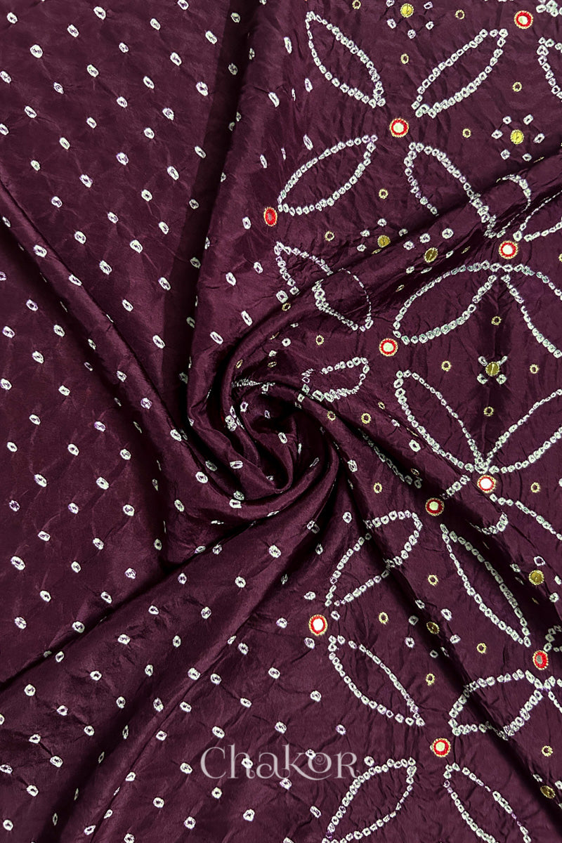 Maroon mulberry silk Bandhani (Rai Bandhej) fabric with white tie-dyed motifs, zari embroidered red mirror and sequin embellishment, arranged in a swirling design  – CHAKOR.
