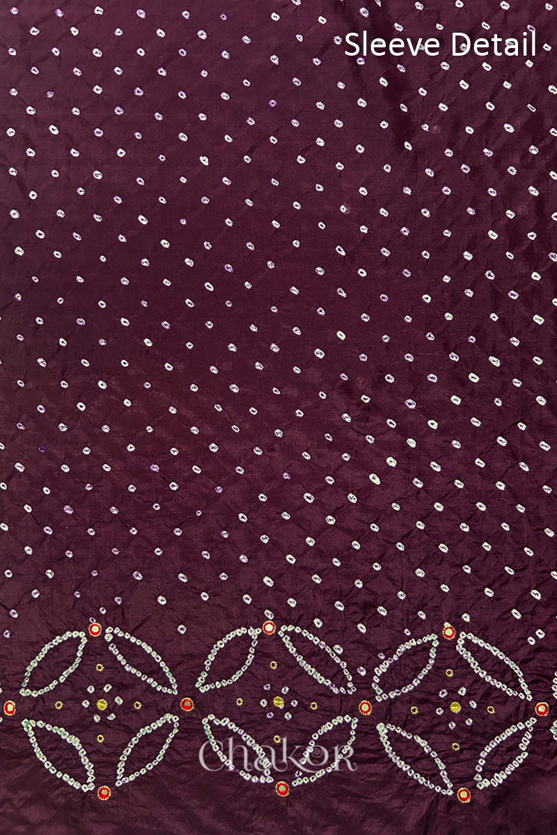 Sleeve detail of Maroon mulberry silk Bandhani (Rai Bandhej) fabric with white dots, floral bandhej borders and red with zari mirror embroidery – CHAKOR.
