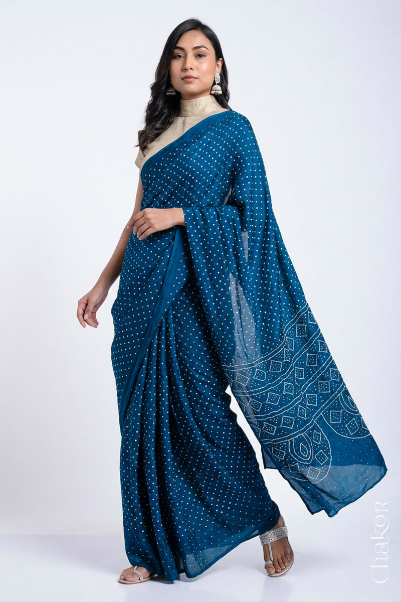 Model wearing indigo blue Bandhani Mulberry Silk Saree, handcrafted in rai bandhej patterns with mukaish embroidery.