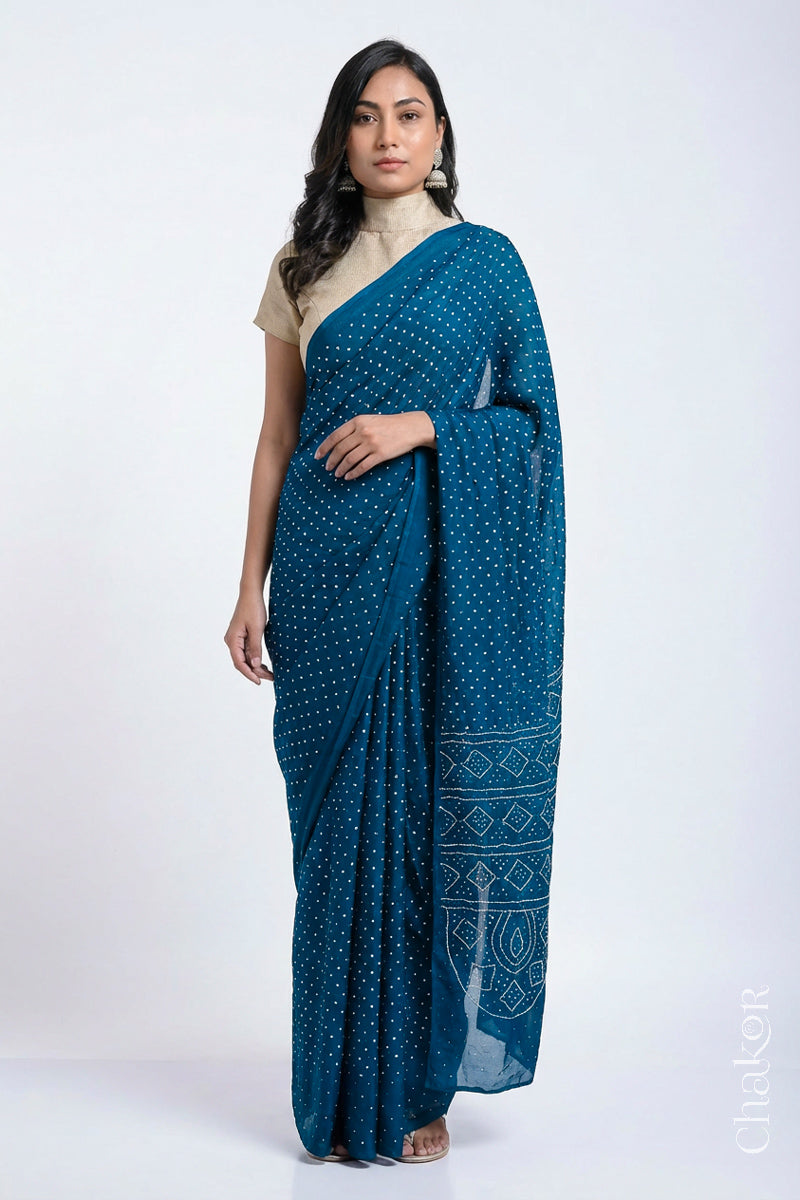 Model wearing indigo blue Bandhani Mulberry Silk Saree, handcrafted in rai bandhej patterns with mukaish embroidery.