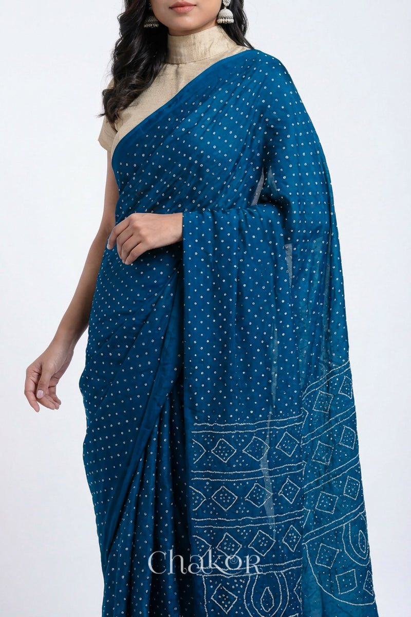 Model wearing indigo blue Bandhani Mulberry Silk Saree, handcrafted in rai bandhej patterns with mukaish embroidery.