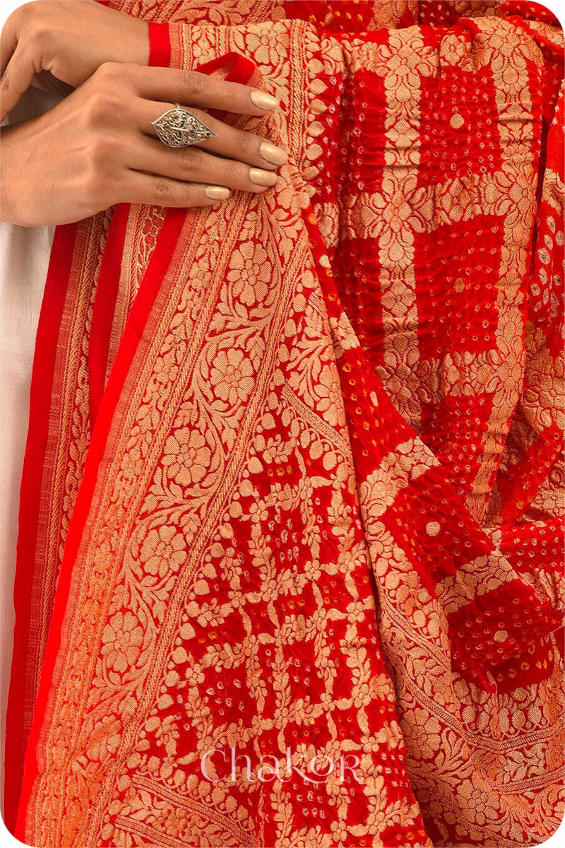 Chakor's Traditional Orange Red shaded Gharchola Bandhani Banarasi Georgette Silk Dupatta.