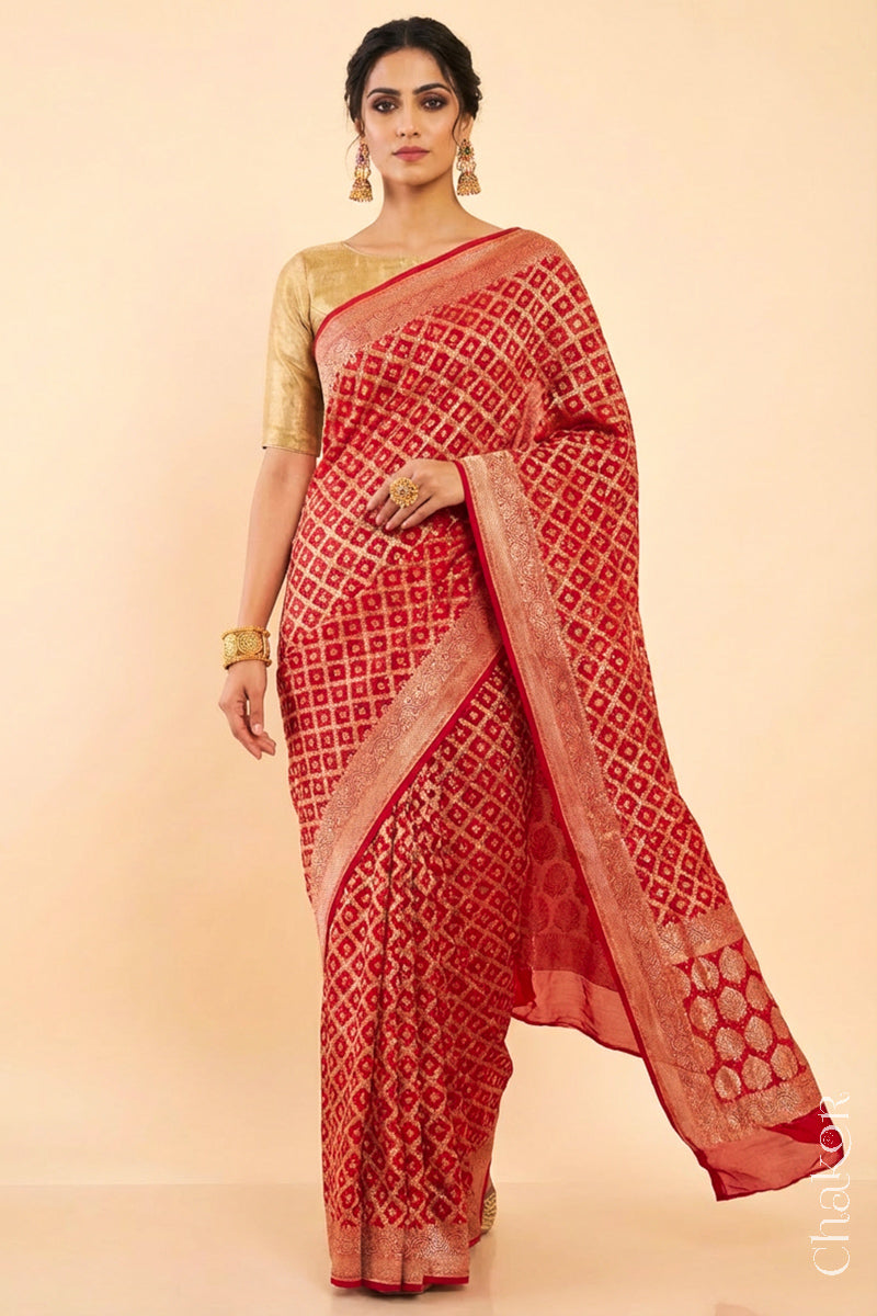 Woman wearing Handcrafted Red Bandhani Banarasi Georgette Silk Saree featuring zari weaving and Kutch rai bandhej.