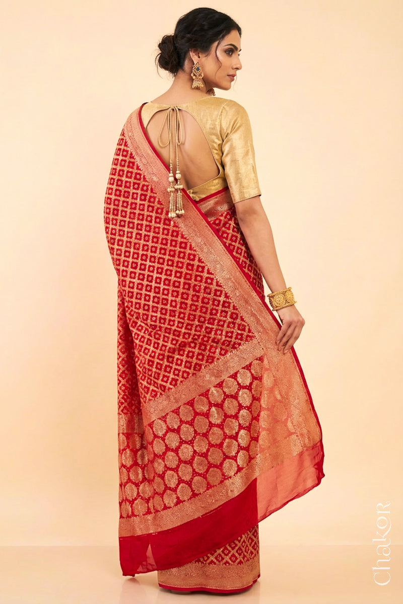 Woman wearing Handcrafted Red Bandhani Banarasi Georgette Silk Saree featuring zari weaving and Kutch rai bandhej.