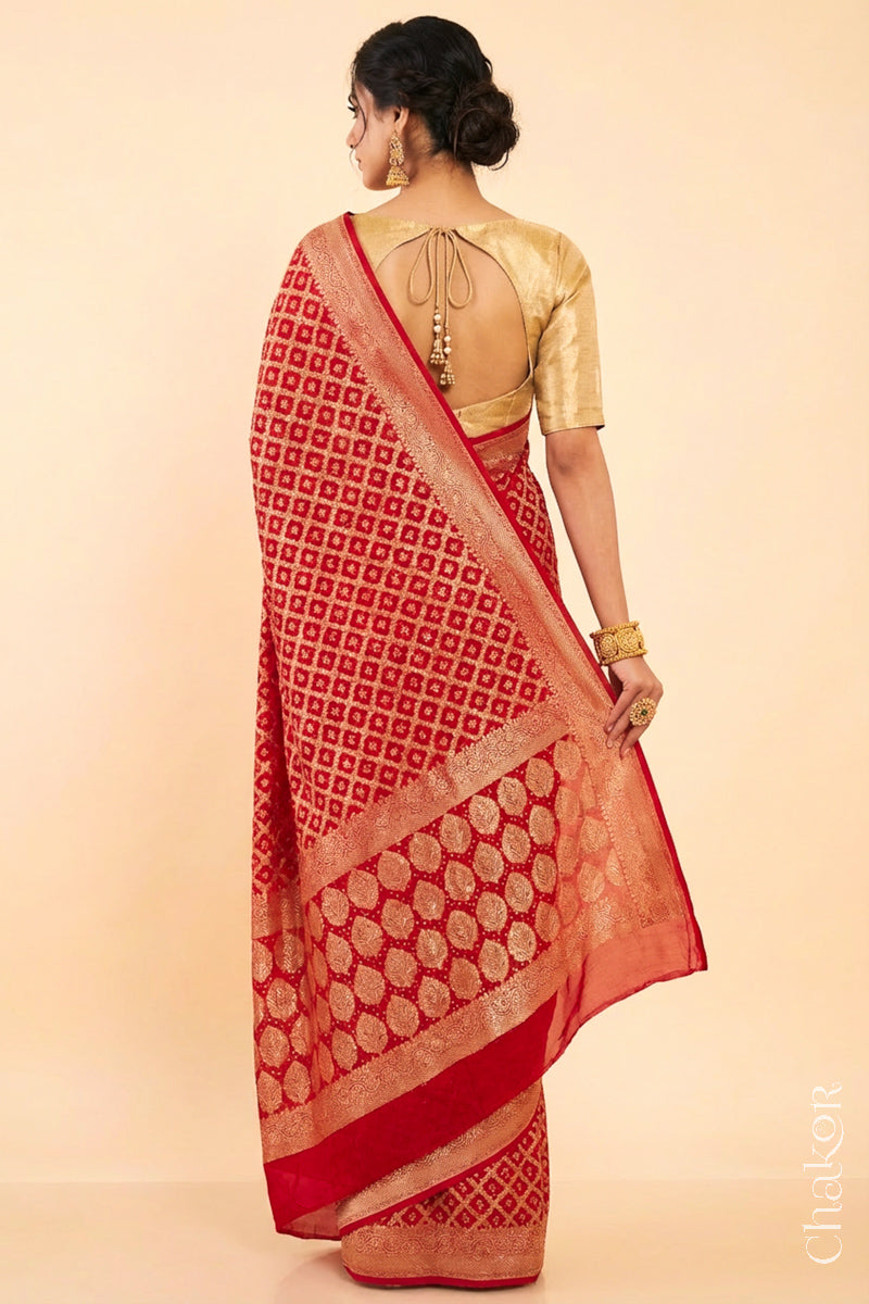 Woman wearing Handcrafted Red Bandhani Banarasi Georgette Silk Saree featuring zari weaving and Kutch rai bandhej.