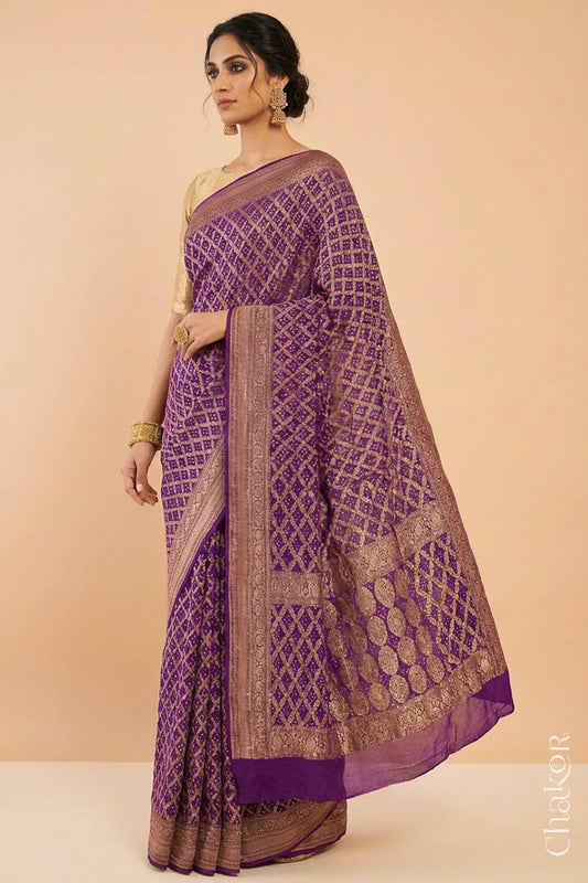 Woman wearing Handcrafted purple Bandhani Banarasi Georgette Saree in pure silk featuring zari weaving and Kutch Bandhej for weddings and occasions.