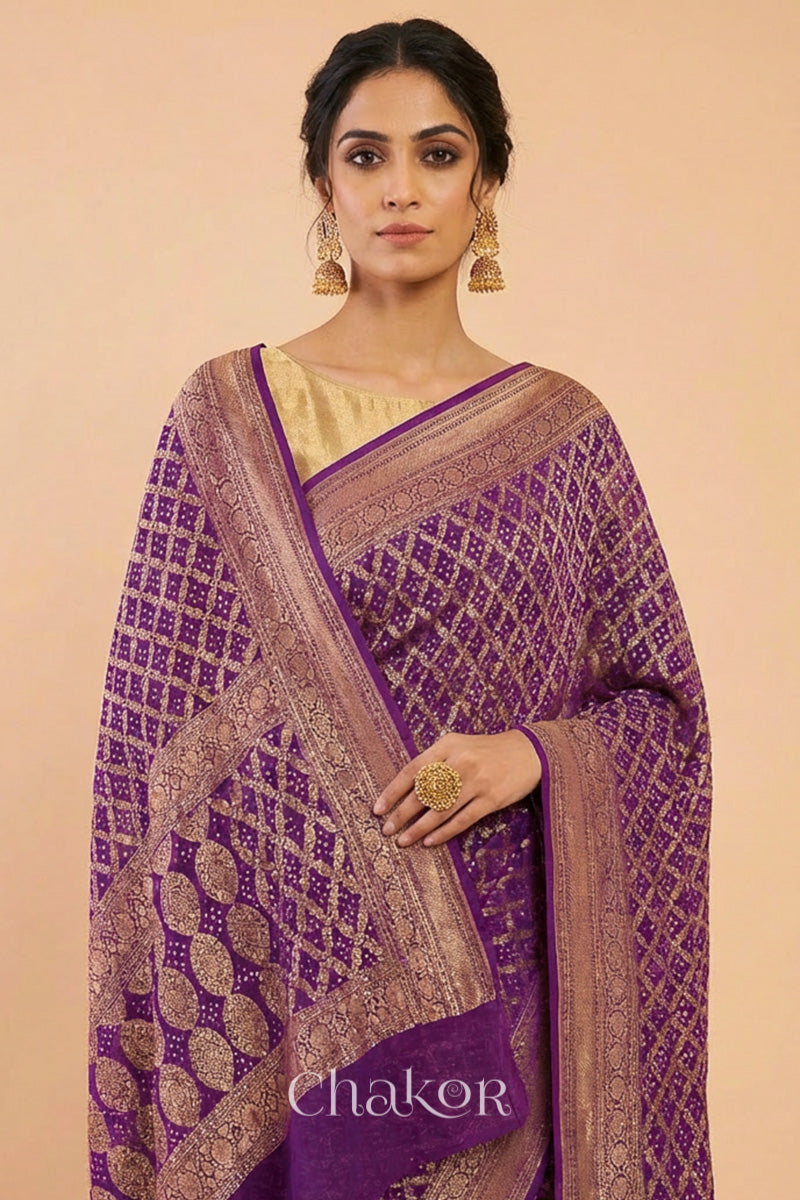 Woman wearing Handcrafted Purple Bandhani Banarasi Georgette Saree in pure silk featuring zari weaving and Kutch Bandhej for weddings and occasions.