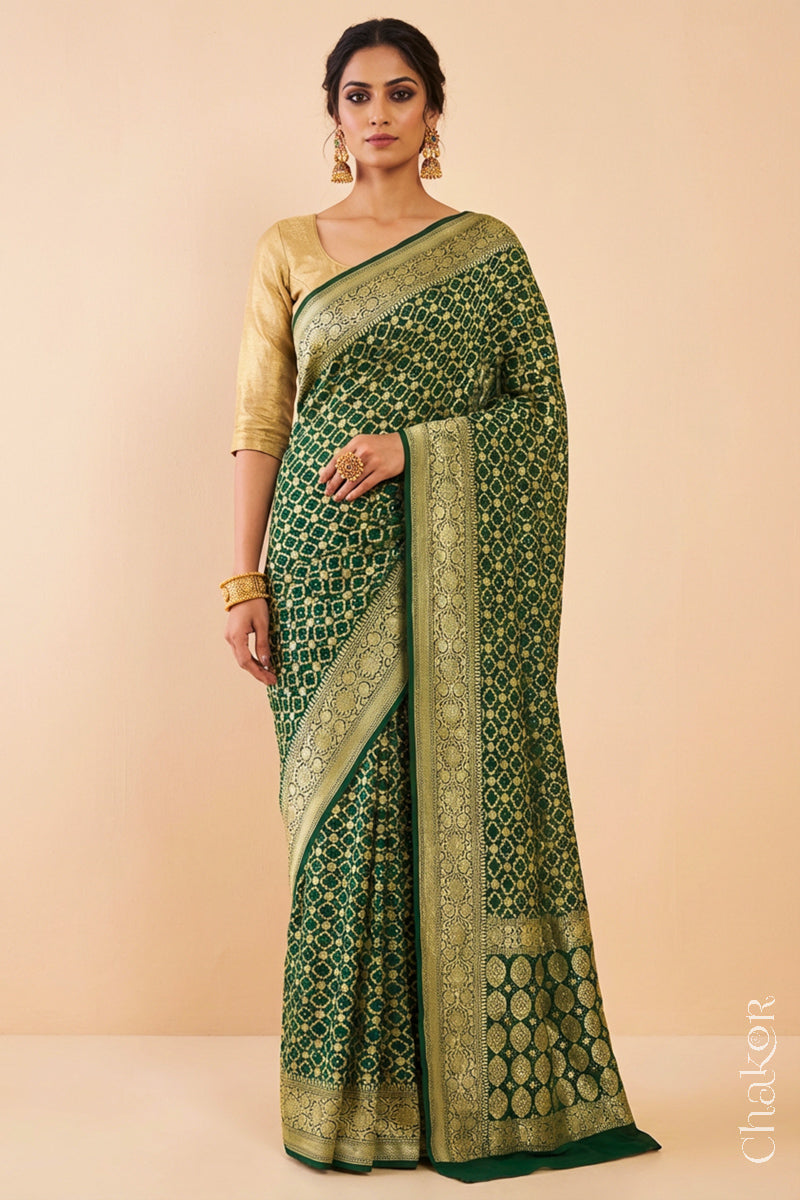 Woman wearing Handcrafted Green Bandhani Banarasi Georgette Saree in pure silk featuring zari weaving and Kutch Bandhej for weddings and occasions.
