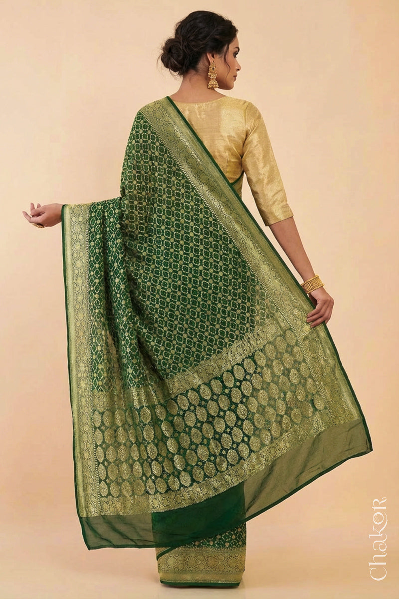 Woman wearing Handcrafted Green Bandhani Banarasi Georgette Saree in pure silk featuring zari weaving and Kutch Bandhej for weddings and occasions.