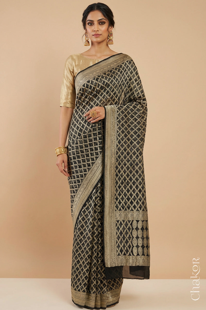 Woman wearing Handcrafted Black Bandhani Banarasi Georgette Saree in pure silk featuring zari weaving and Kutch Bandhej for weddings and occasions.