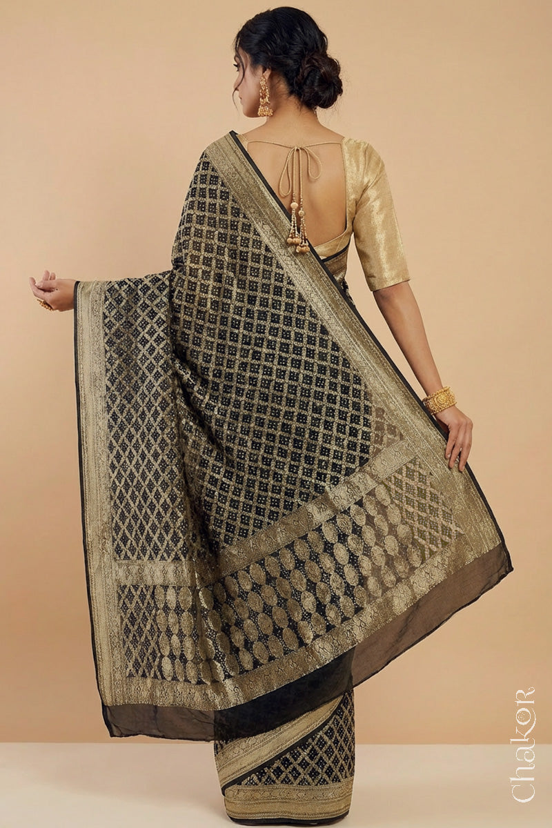 Woman wearing Handcrafted Black Bandhani Banarasi Georgette Saree in pure silk featuring zari weaving and Kutch Bandhej for weddings and occasions.