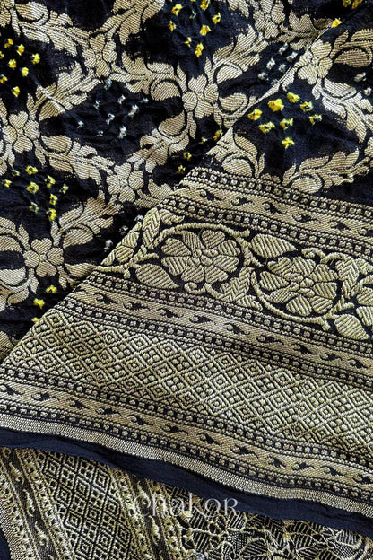 Close up of Handcrafted Black Bandhani Banarasi Georgette Saree in pure silk featuring zari weaving and Kutch Bandhej for weddings and occasions.