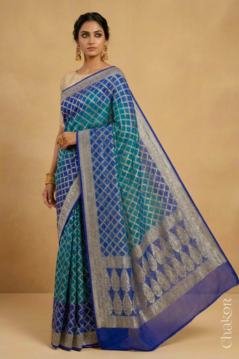 Woman wearing Handcrafted Peacock Blue  Bandhani Banarasi Georgette Silk Saree featuring zari weaving and kutch rai bandhej.