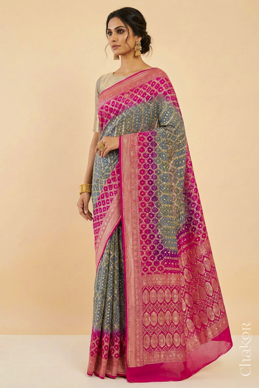 Woman wearing Handcrafted Pink and grey ombre shaded Bandhani Banarasi Georgette Silk Saree featuring zari weaving and Kutch Bandhej.