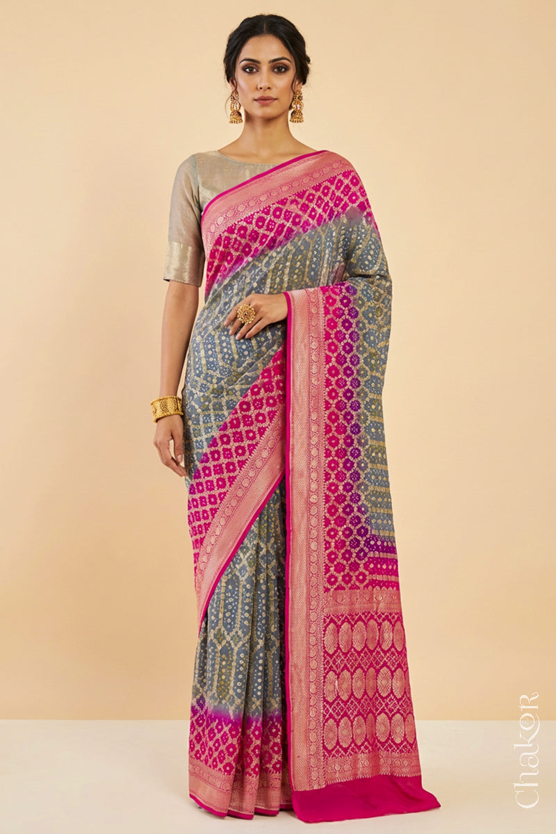 Woman wearing Handcrafted Pink and grey ombre shaded Bandhani Banarasi Georgette Silk Saree featuring zari weaving and Kutch Bandhej.