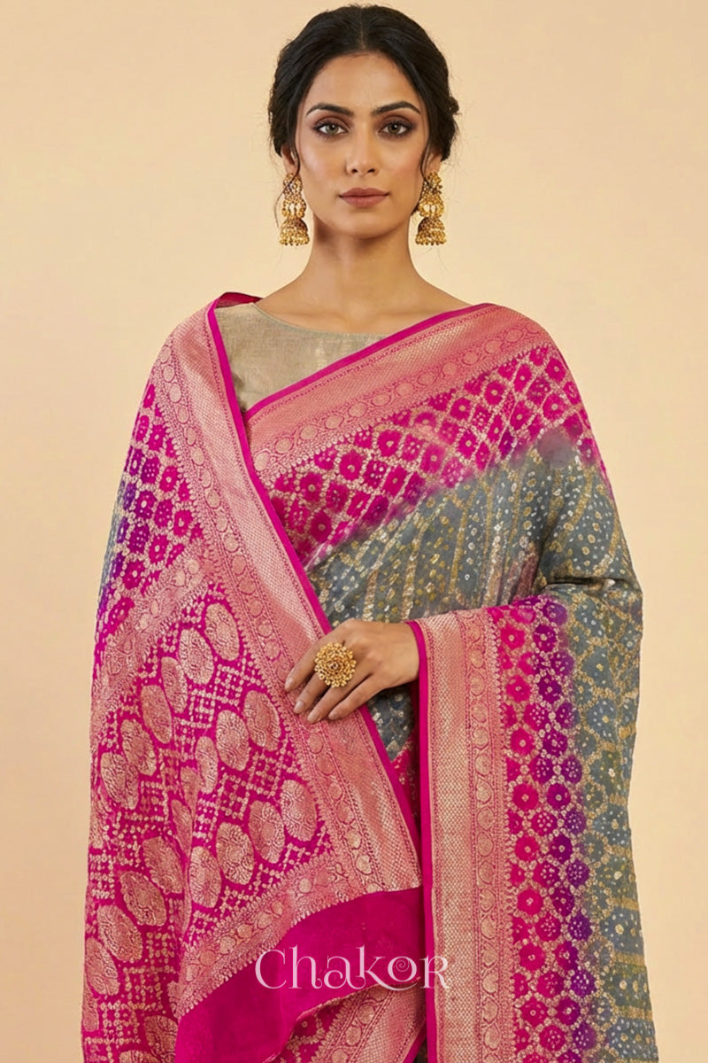 Woman wearing Handcrafted Pink and grey ombre shaded Bandhani Banarasi Georgette Silk Saree featuring zari weaving and Kutch Bandhej.