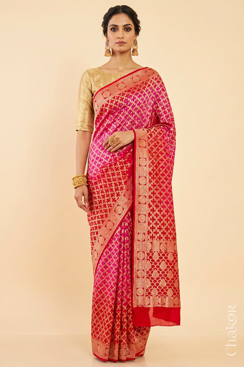 Woman wearing Handcrafted Pink Red ombre shaded Bandhani Banarasi Georgette Saree in pure silk featuring zari weaving and Kutch Bandhej for weddings and occasions.