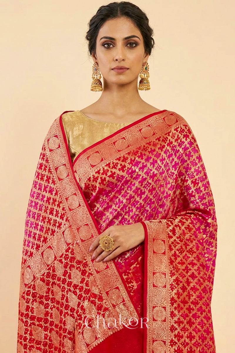 Woman wearing Handcrafted Pink Red ombre shaded Bandhani Banarasi Georgette Saree in pure silk featuring zari weaving and Kutch Bandhej for weddings and occasions.