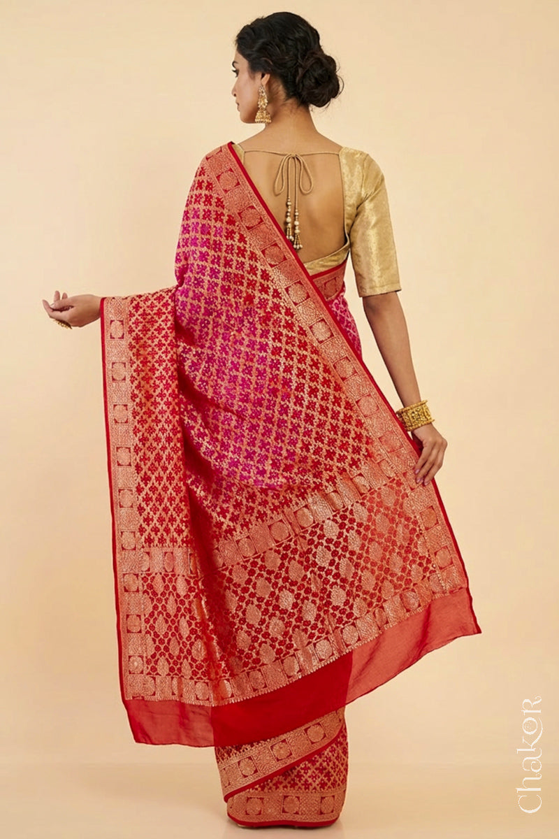 Woman wearing Handcrafted Pink Red ombre shaded Bandhani Banarasi Georgette Saree in pure silk featuring zari weaving and Kutch Bandhej for weddings and occasions.
