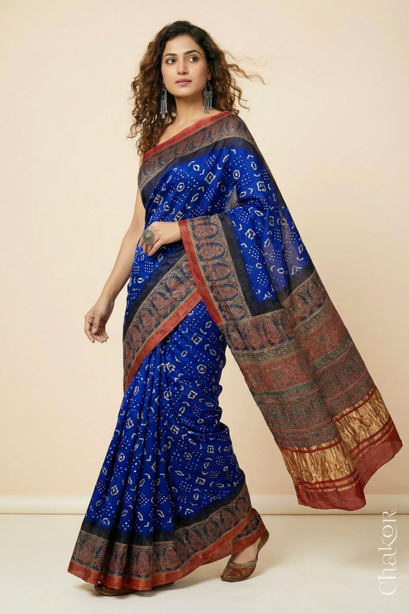 Woman wearing Blue Bandhani Saree with Red Ajrakh printed border and pallu in pure gaji silk with traditional bandhej tie-dye, handcrafted in Kutch. 
