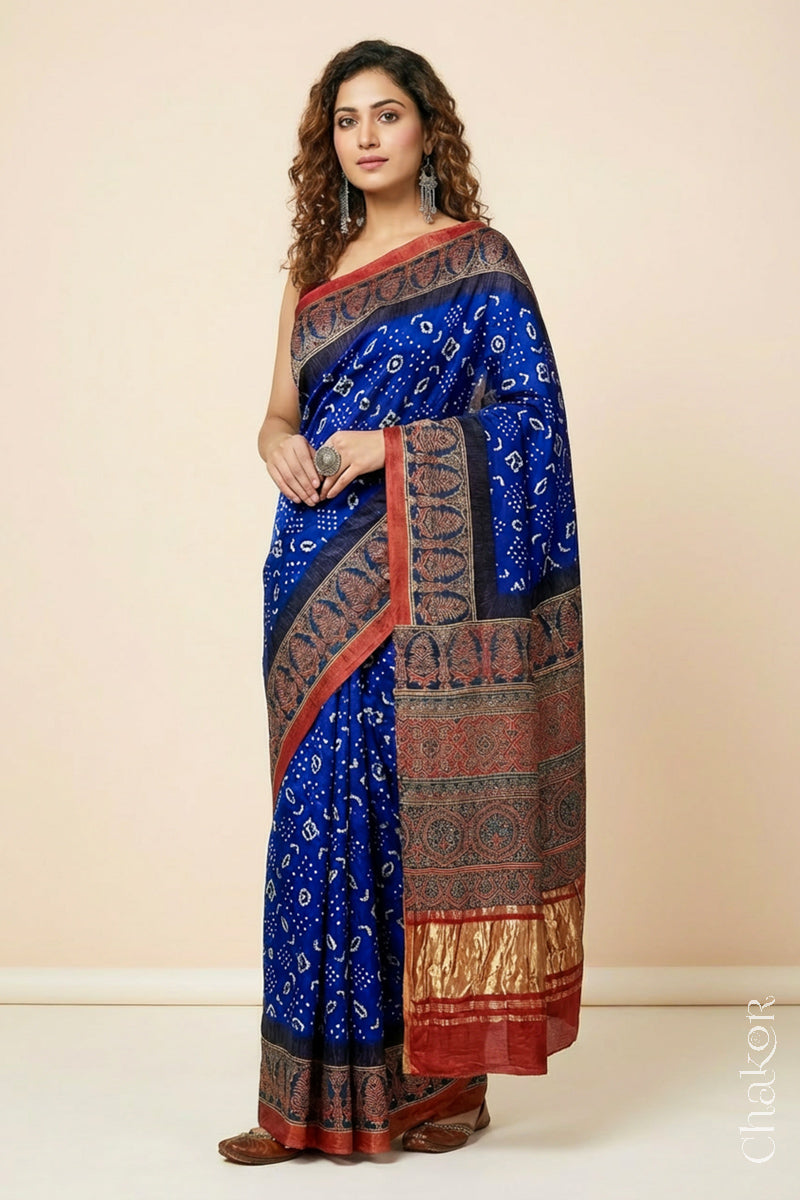 Woman wearing Blue Bandhani Saree with Red Ajrakh printed border and pallu in pure gaji silk with traditional bandhej tie-dye, handcrafted in Kutch. 