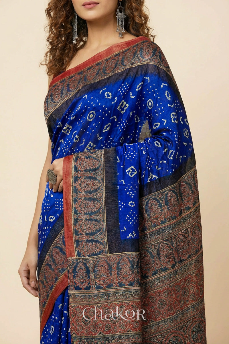 Woman wearing Blue Bandhani Saree with Red Ajrakh printed border and pallu in pure gaji silk with traditional bandhej tie-dye, handcrafted in Kutch. 