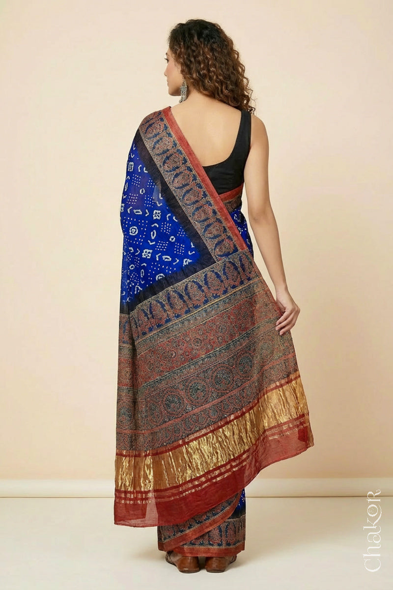 Woman wearing Blue Bandhani Saree with Red Ajrakh printed border and pallu in pure gaji silk with traditional bandhej tie-dye, handcrafted in Kutch. 