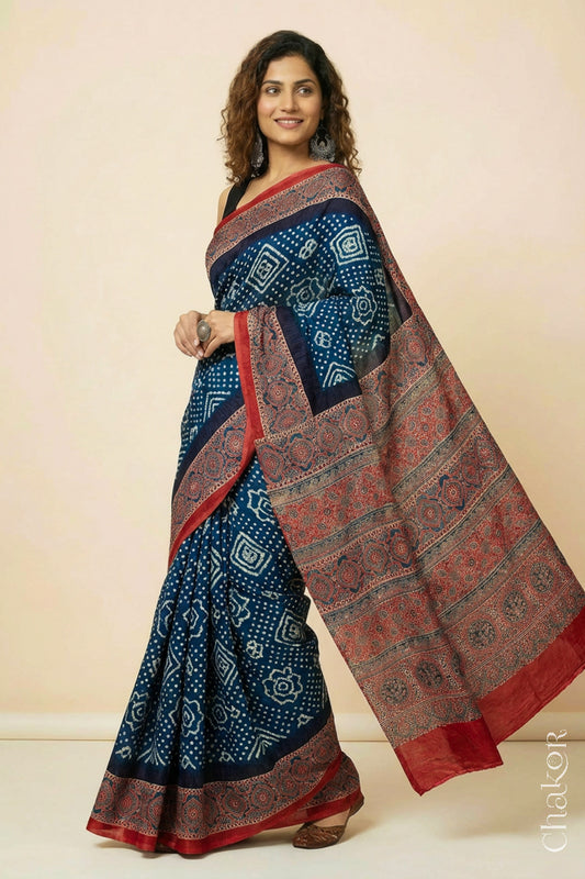 Woman wearing Navy Bandhani Saree with Red Ajrakh printed border and pallu in pure gaji silk with traditional bandhej tie-dye, handcrafted in Kutch. 