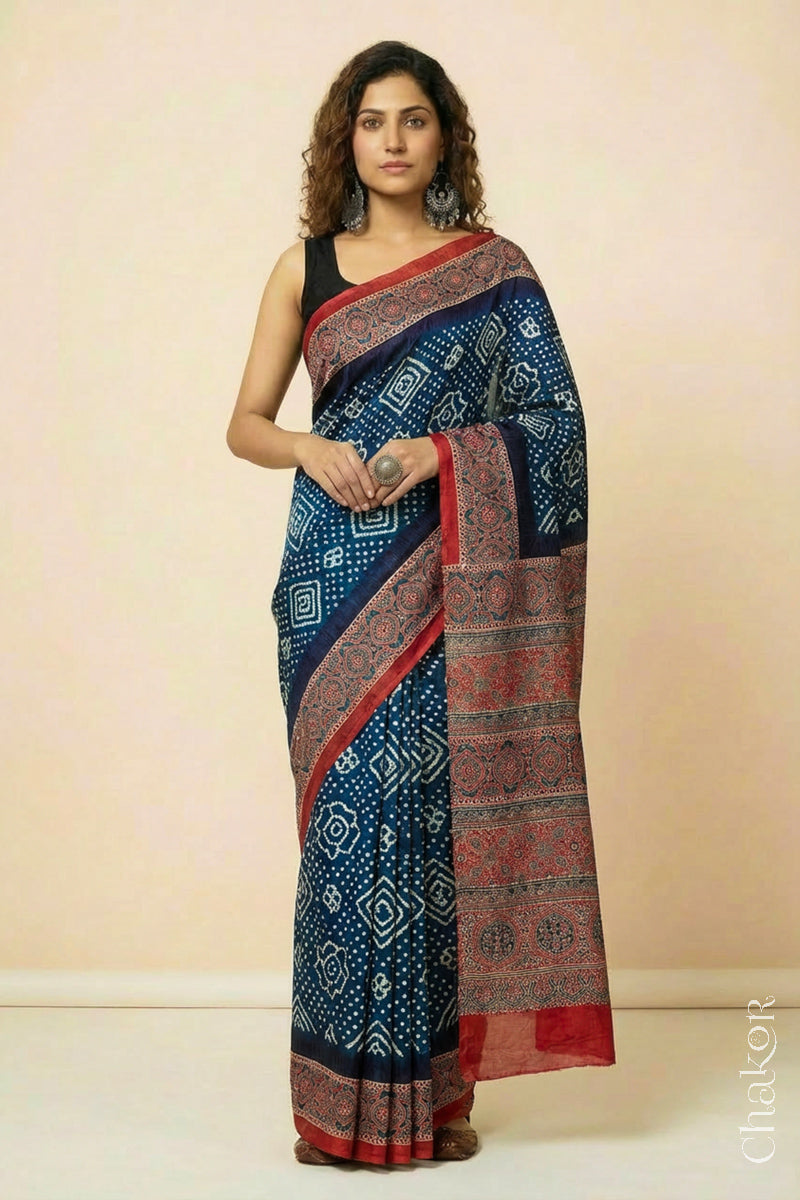 Woman wearing Navy Bandhani Saree with Red Ajrakh printed border and pallu in pure gaji silk with traditional bandhej tie-dye, handcrafted in Kutch. 
