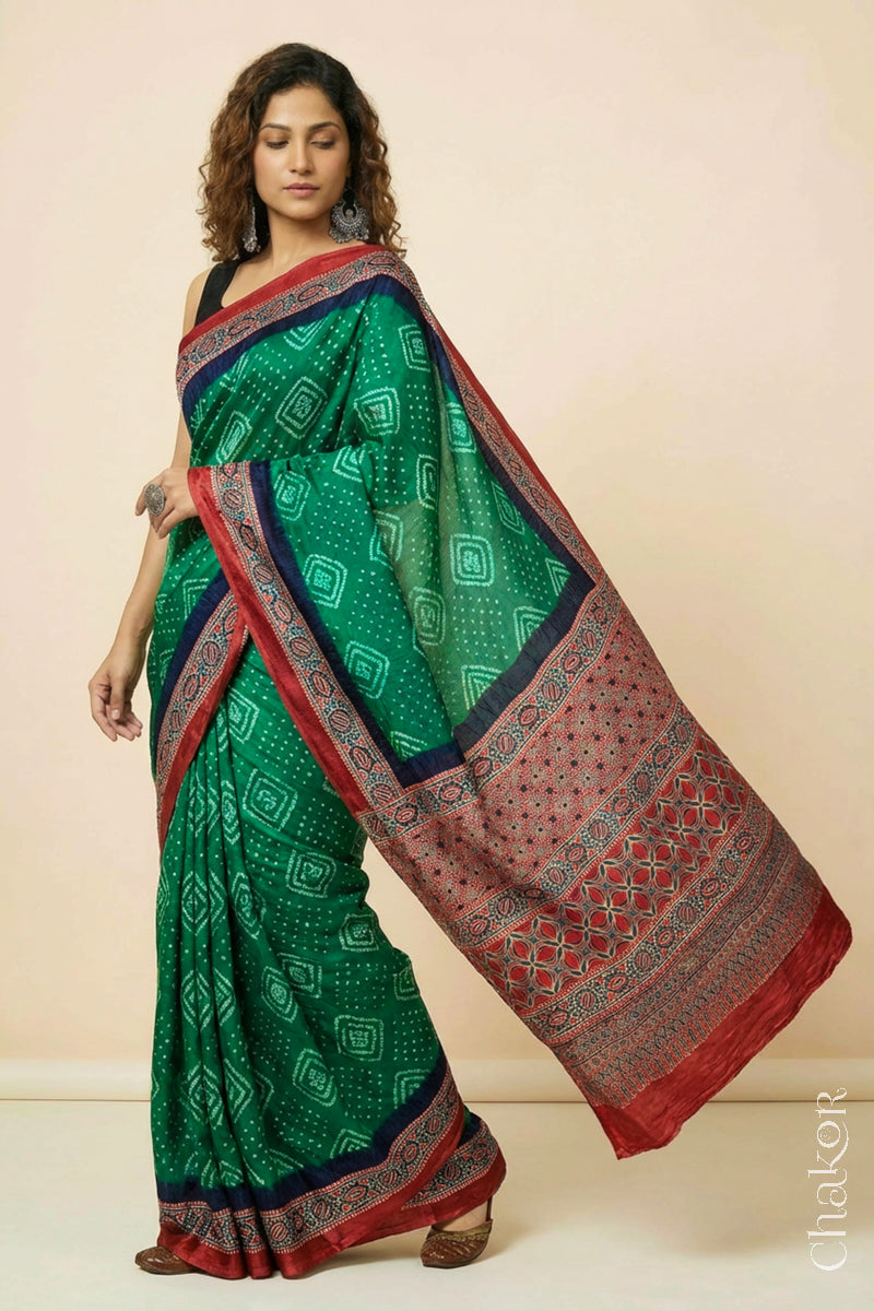 Woman wearing Green Bandhani Saree with Ajrakh printed border and pallu in pure gaji silk with traditional bandhej tie-dye, handcrafted in Kutch. 