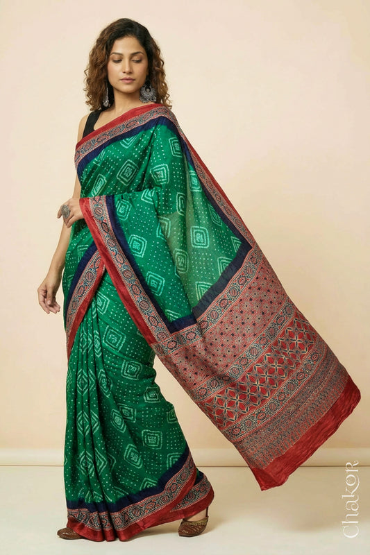 Woman wearing Green Bandhani Saree with Ajrakh printed border and pallu in pure gaji silk with traditional bandhej tie-dye, handcrafted in Kutch. 