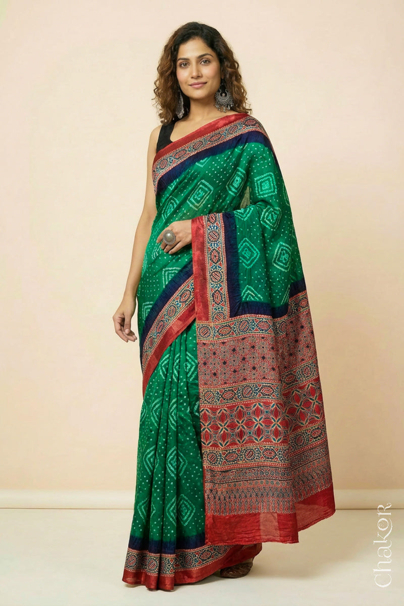 Woman wearing Green Bandhani Saree with Ajrakh printed border and pallu in pure gaji silk with traditional bandhej tie-dye, handcrafted in Kutch. 