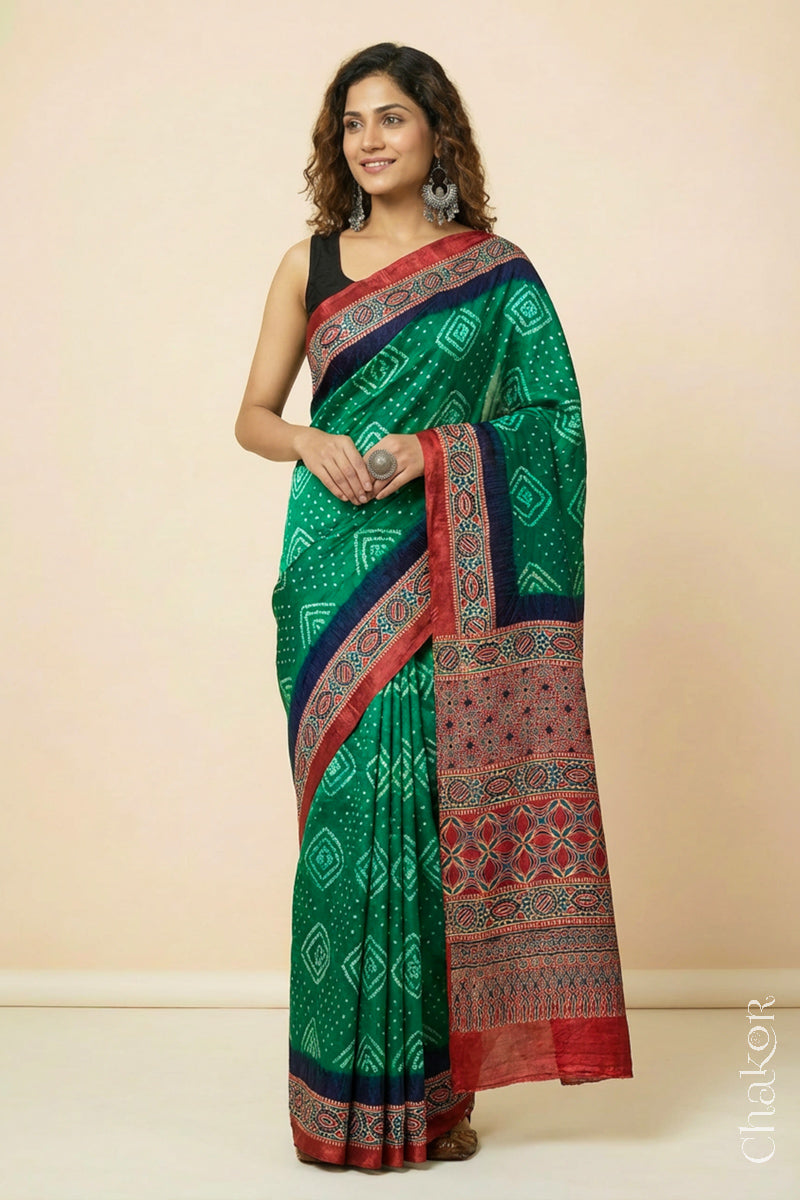 Woman wearing Green Bandhani Saree with Ajrakh printed border and pallu in pure gaji silk with traditional bandhej tie-dye, handcrafted in Kutch. 