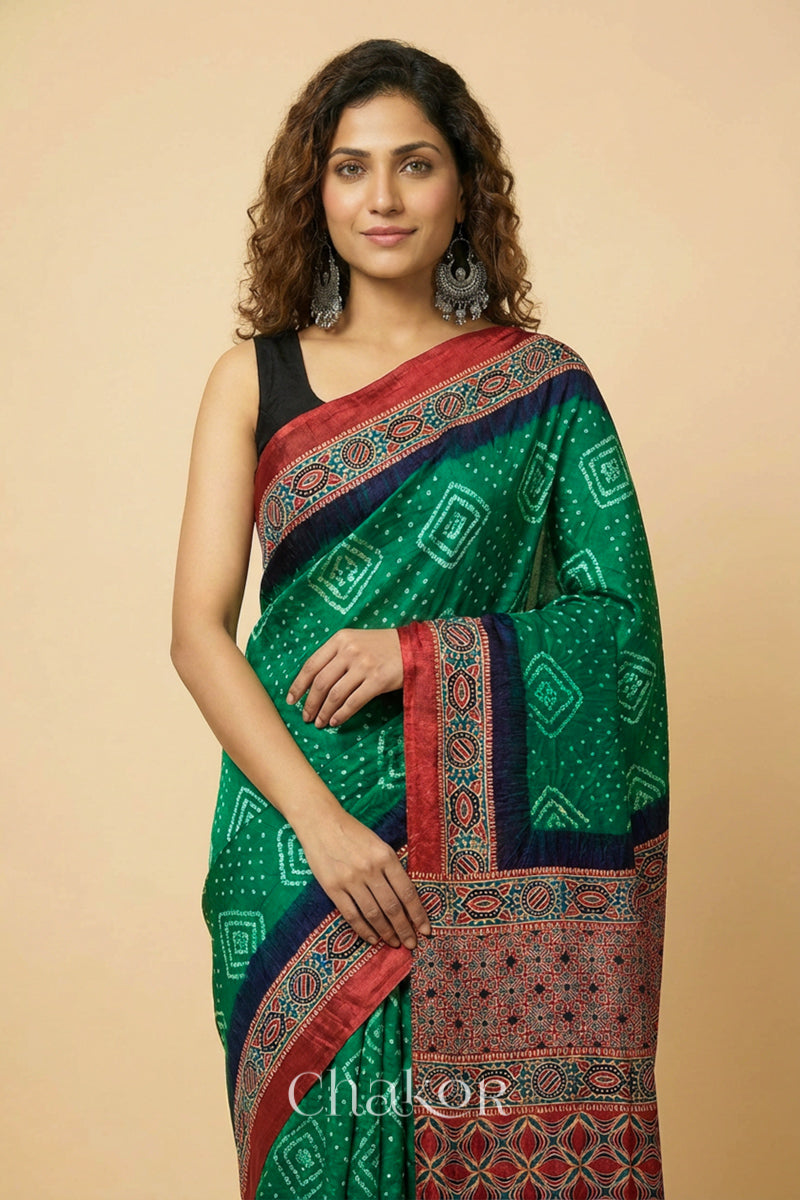 Woman wearing Green Bandhani Saree with Ajrakh printed border and pallu in pure gaji silk with traditional bandhej tie-dye, handcrafted in Kutch. 