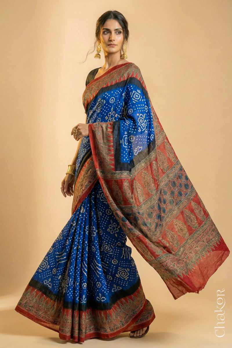 Woman wearing Blue Bandhani Saree with Natural Red Ajrakh printed border and pallu in pure gaji silk with traditional bandhej tie-dye, handcrafted in Kutch. 