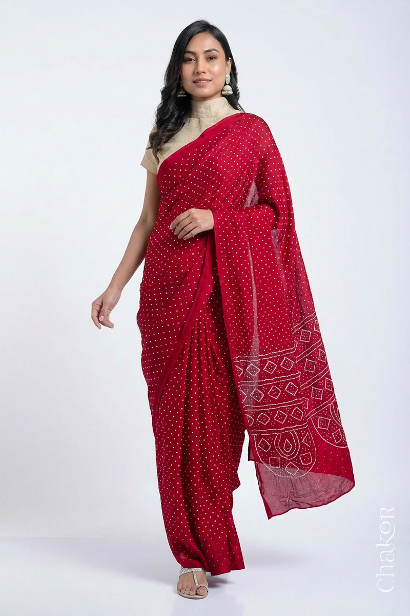 Model wearing Red Bandhani Mulberry Silk Saree, handcrafted in rai bandhej patterns with mukaish embroidery.