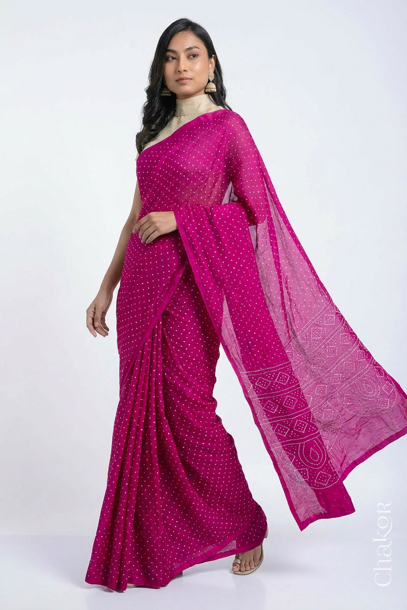 Model wearing Rani pink Bandhani Mulberry Silk Saree, handcrafted in rai bandhej patterns with mukaish embroidery.