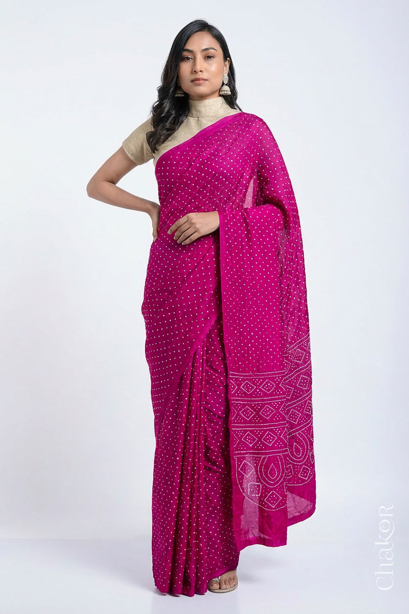 Model wearing Rani pink Bandhani Mulberry Silk Saree, handcrafted in rai bandhej patterns with mukaish embroidery.