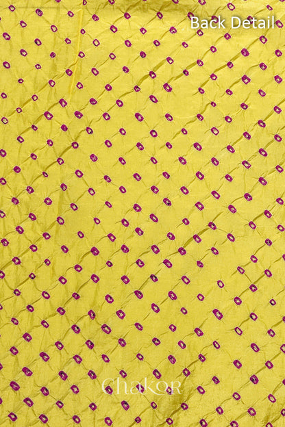 Back detail of Yellow mulberry silk Bandhani (Rai Bandhej) fabric with rani pink tie-dye dots in an all-over pattern – CHAKOR.

