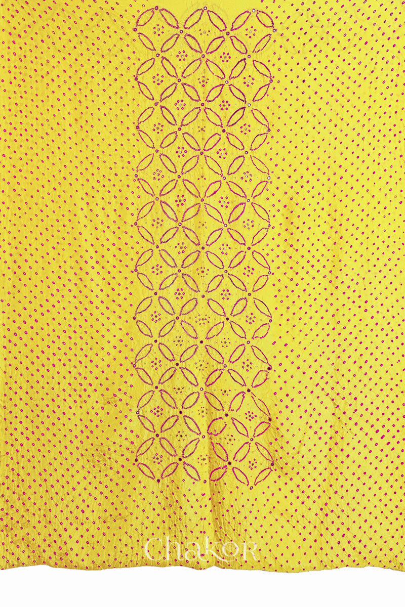 Full fabric panel of Yellow mulberry silk Bandhani (Rai Bandhej) with all-over rani pink dots and a floral border with pink with zari mirror & sequins embroidery – CHAKOR.
