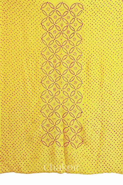 Full fabric panel of Yellow mulberry silk Bandhani (Rai Bandhej) with all-over rani pink dots and a floral border with pink with zari mirror & sequins embroidery – CHAKOR.

