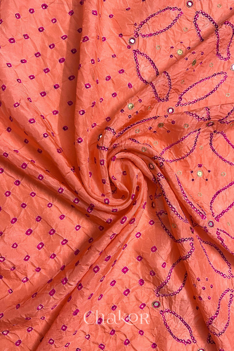 Coral pink mulberry silk Bandhani (Rai Bandhej) fabric with rani pink tie-dyed motifs, pink with zari mirror and sequin embellishment, arranged in a swirling design  – CHAKOR.