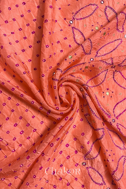 Coral pink mulberry silk Bandhani (Rai Bandhej) fabric with rani pink tie-dyed motifs, pink with zari mirror and sequin embellishment, arranged in a swirling design  – CHAKOR.